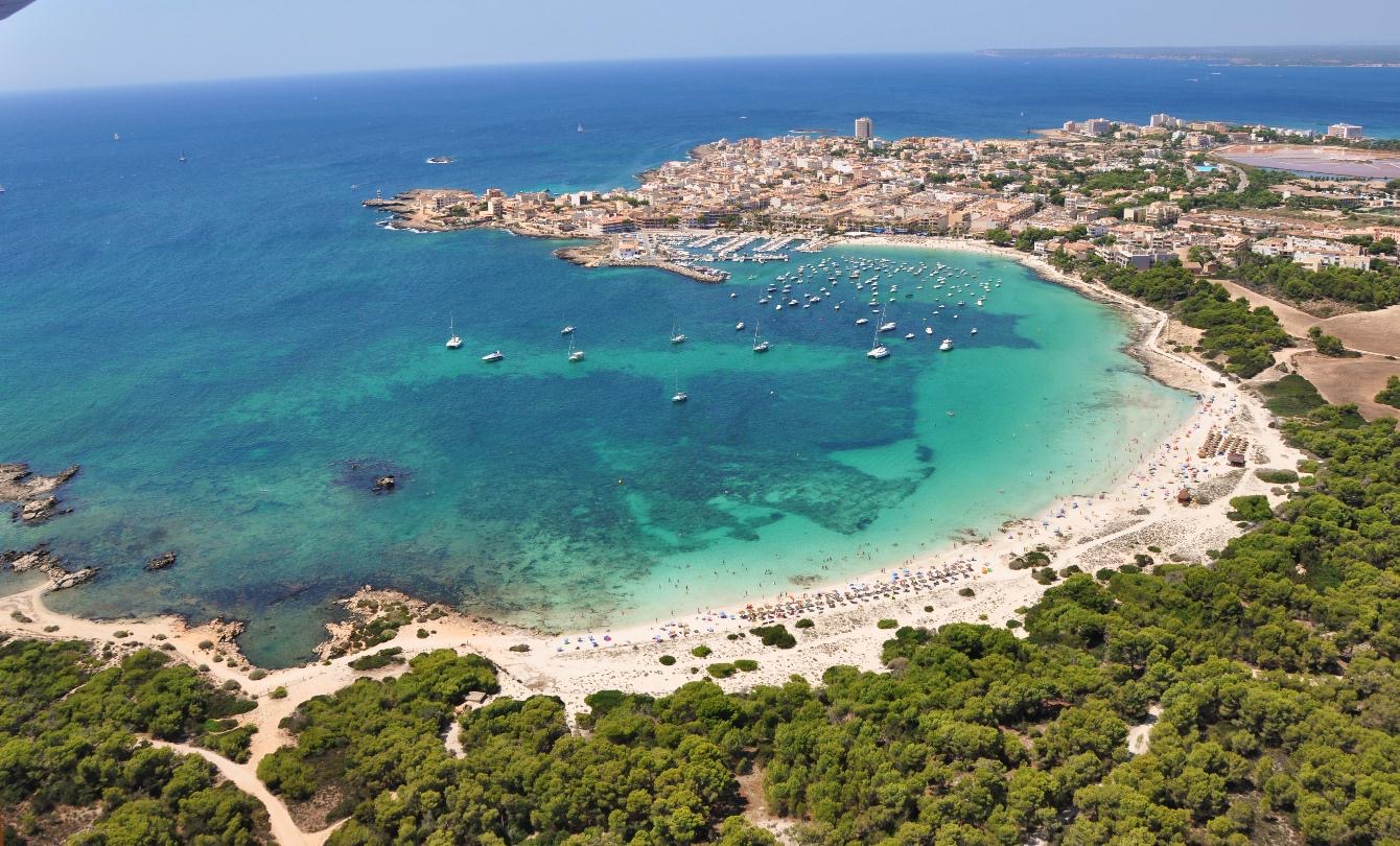 An aerial view of a sheltered cove and small harbour on the south coast