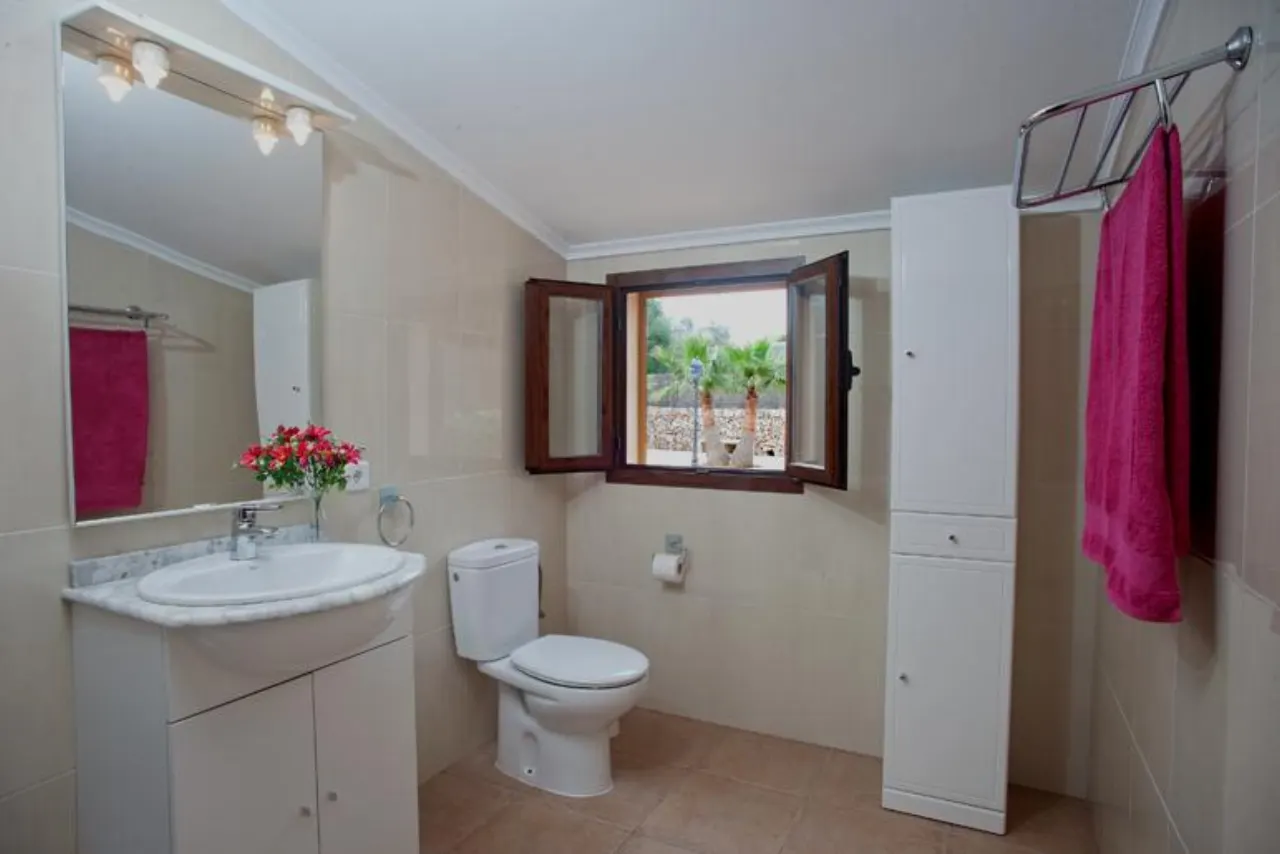 A bathroom with a shuttered window at the finca