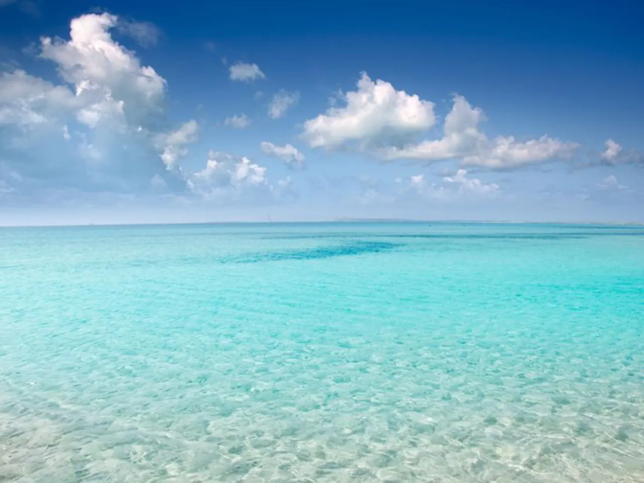 Open clear turquoise water under a wide sky on the south coast of Mallorca